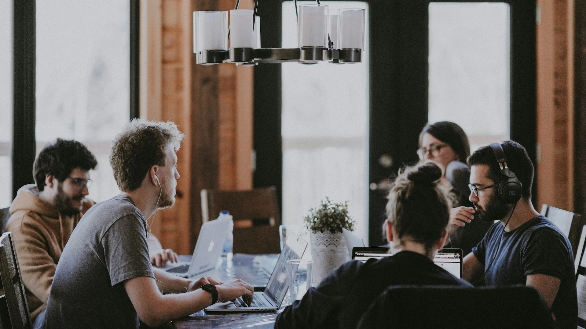 Group of high-agency collaborators working together with technology